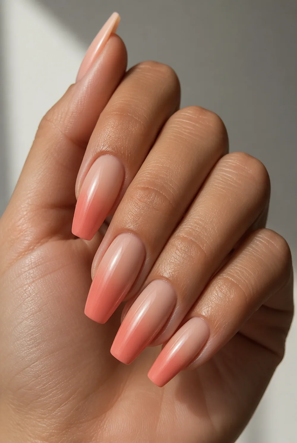 coral ombre nail art on olive skin, long length