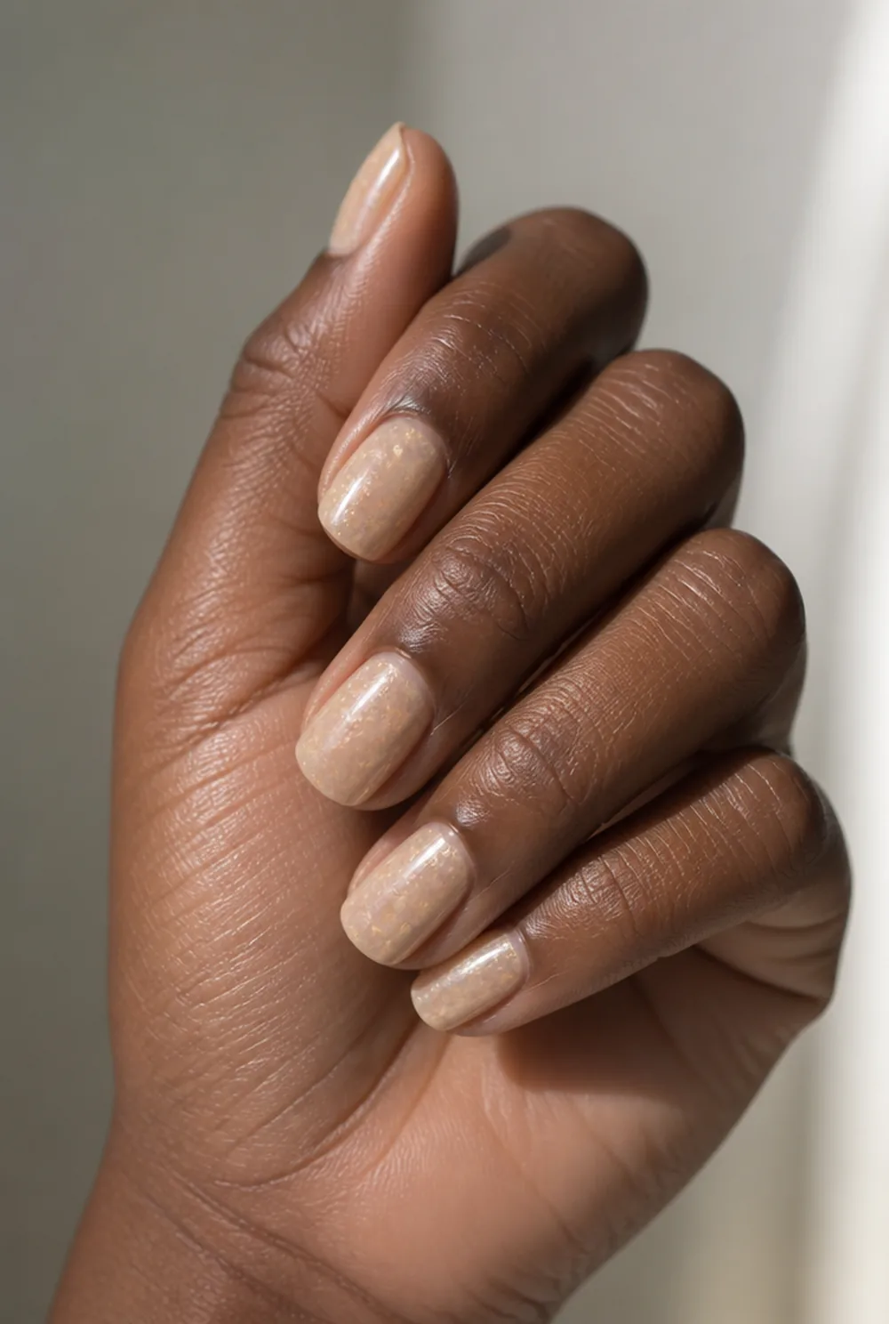 encapsulated crushed shell nail art on deep brown skin