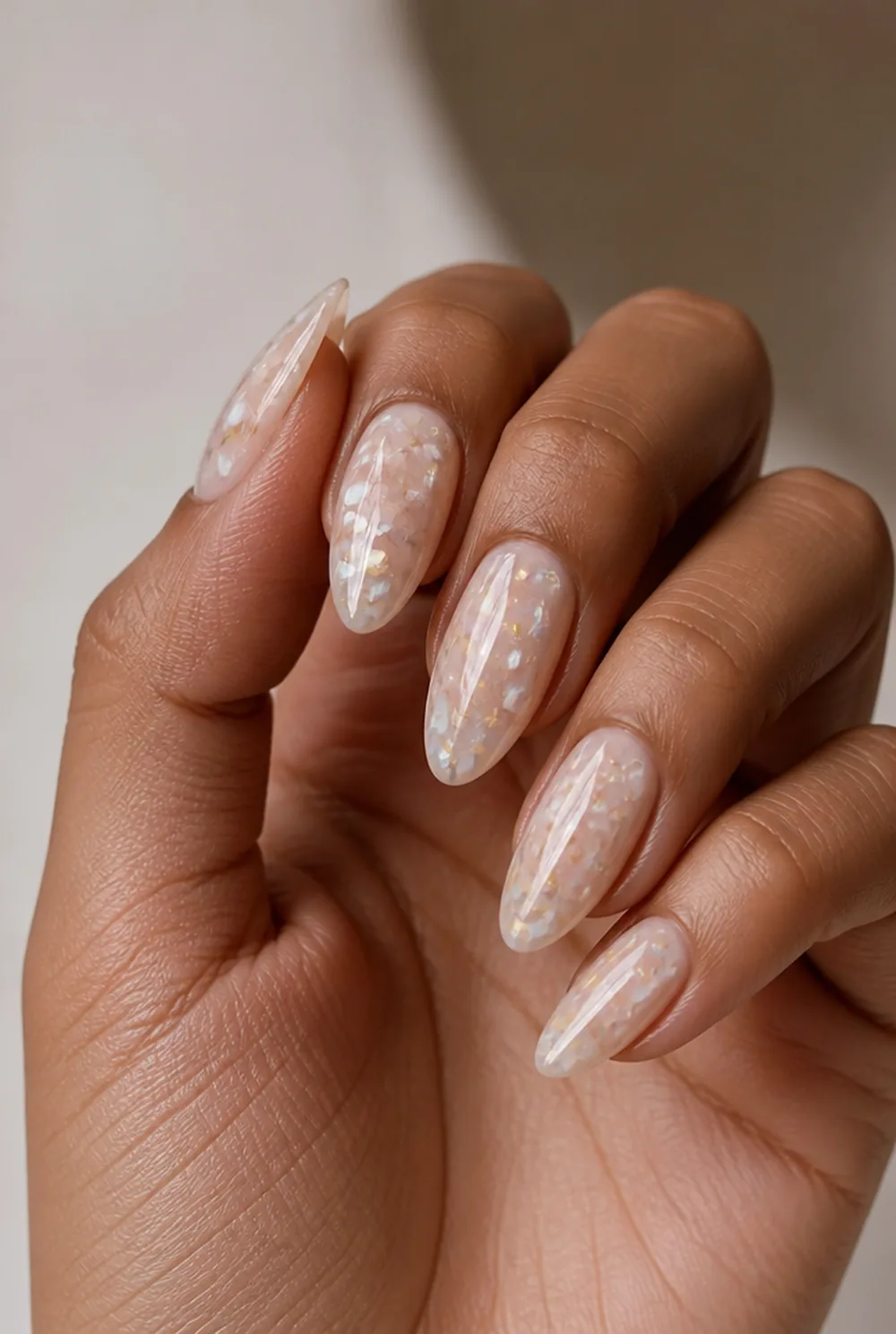 encapsulated crushed shell nail art on olive skin, long length