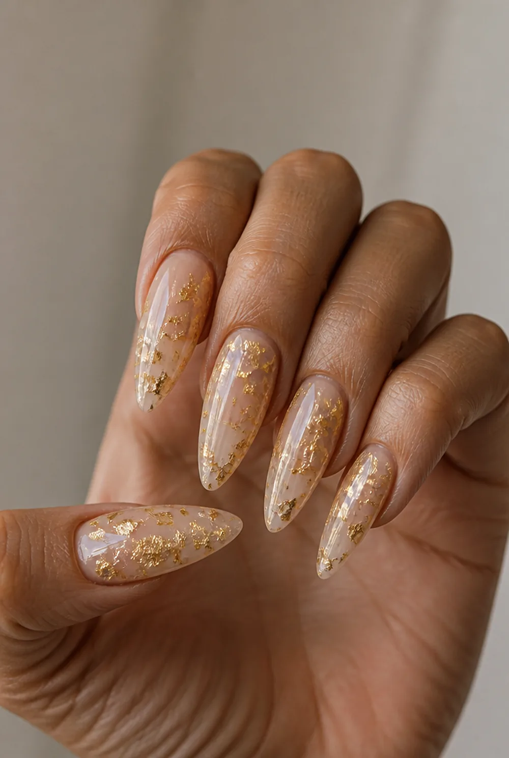 encapsulated gold foil nail art on olive skin, long length