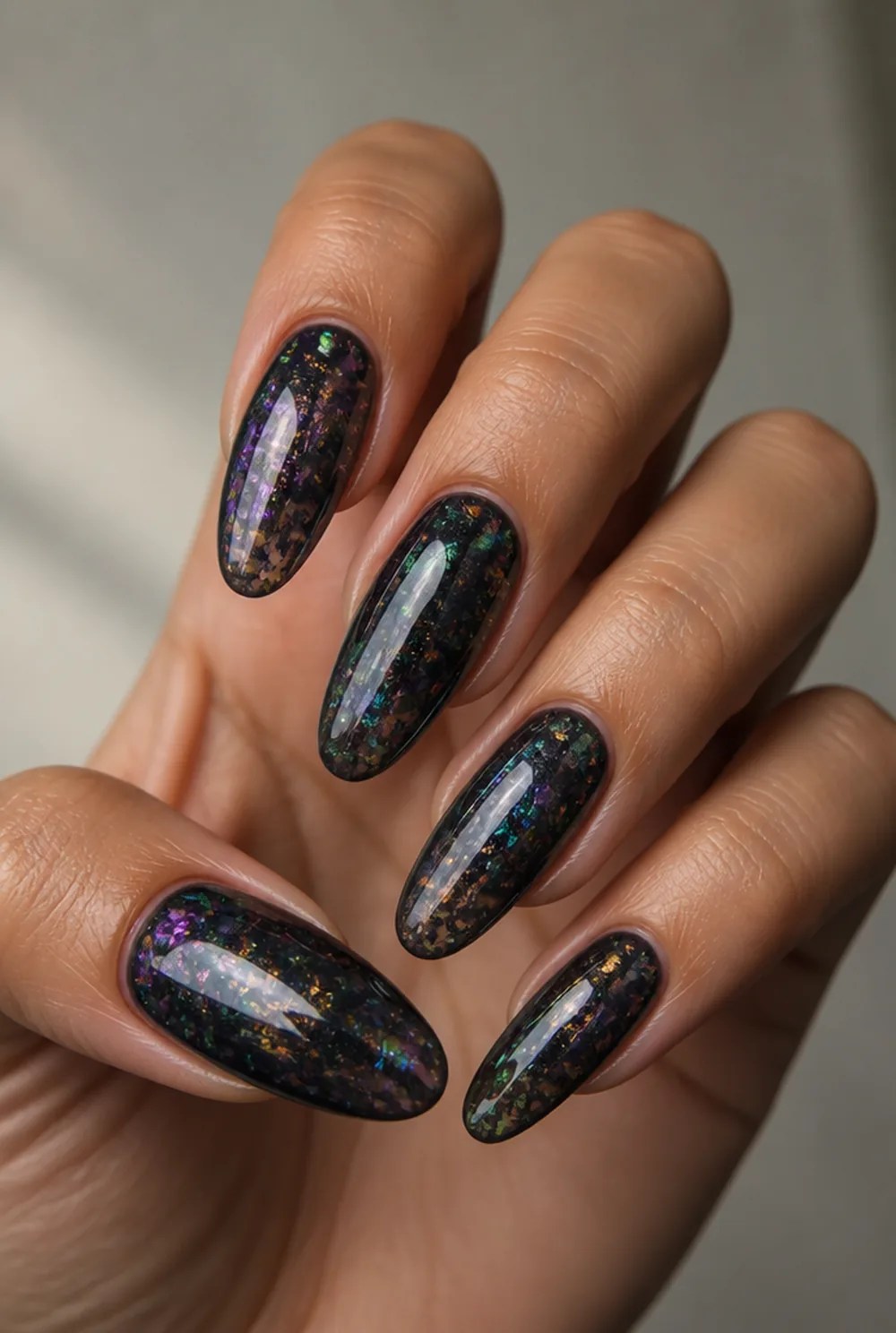 encapsulated chrome flakes nail art on olive skin, long length