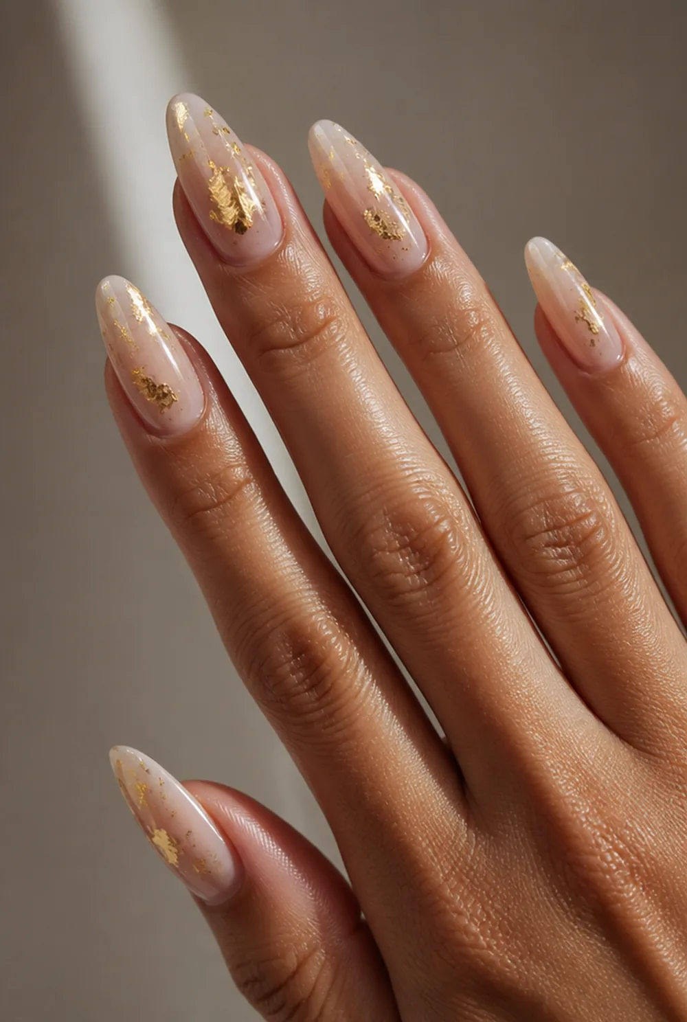 gold leaf shards nail art on olive skin, long length