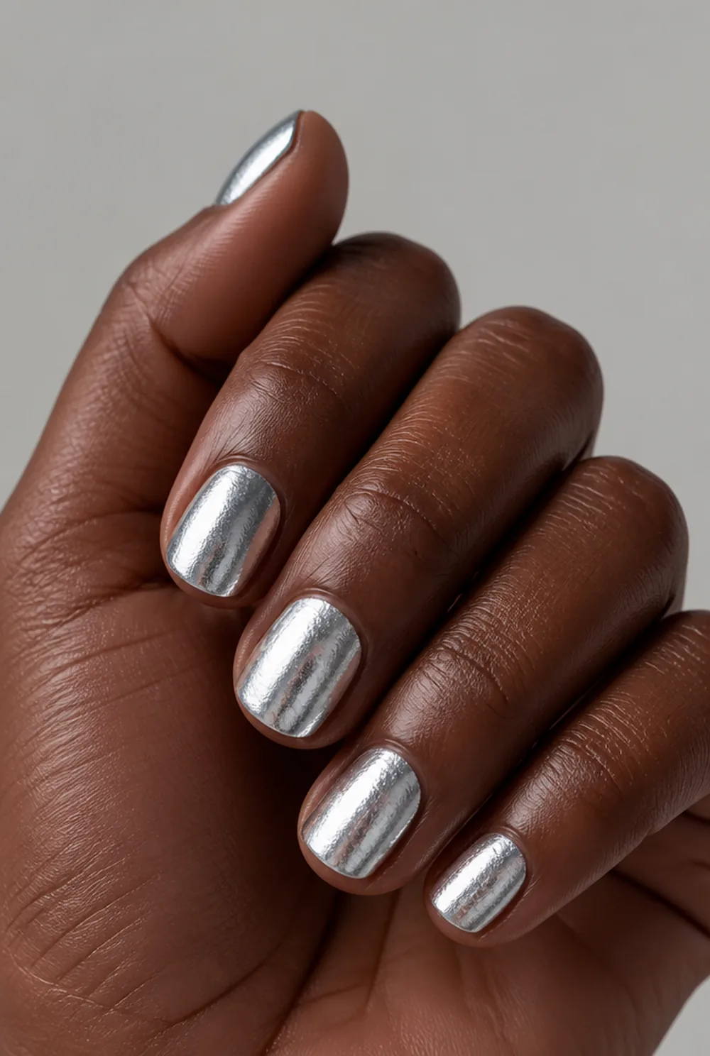 full mirror foil nail art on deep brown skin
