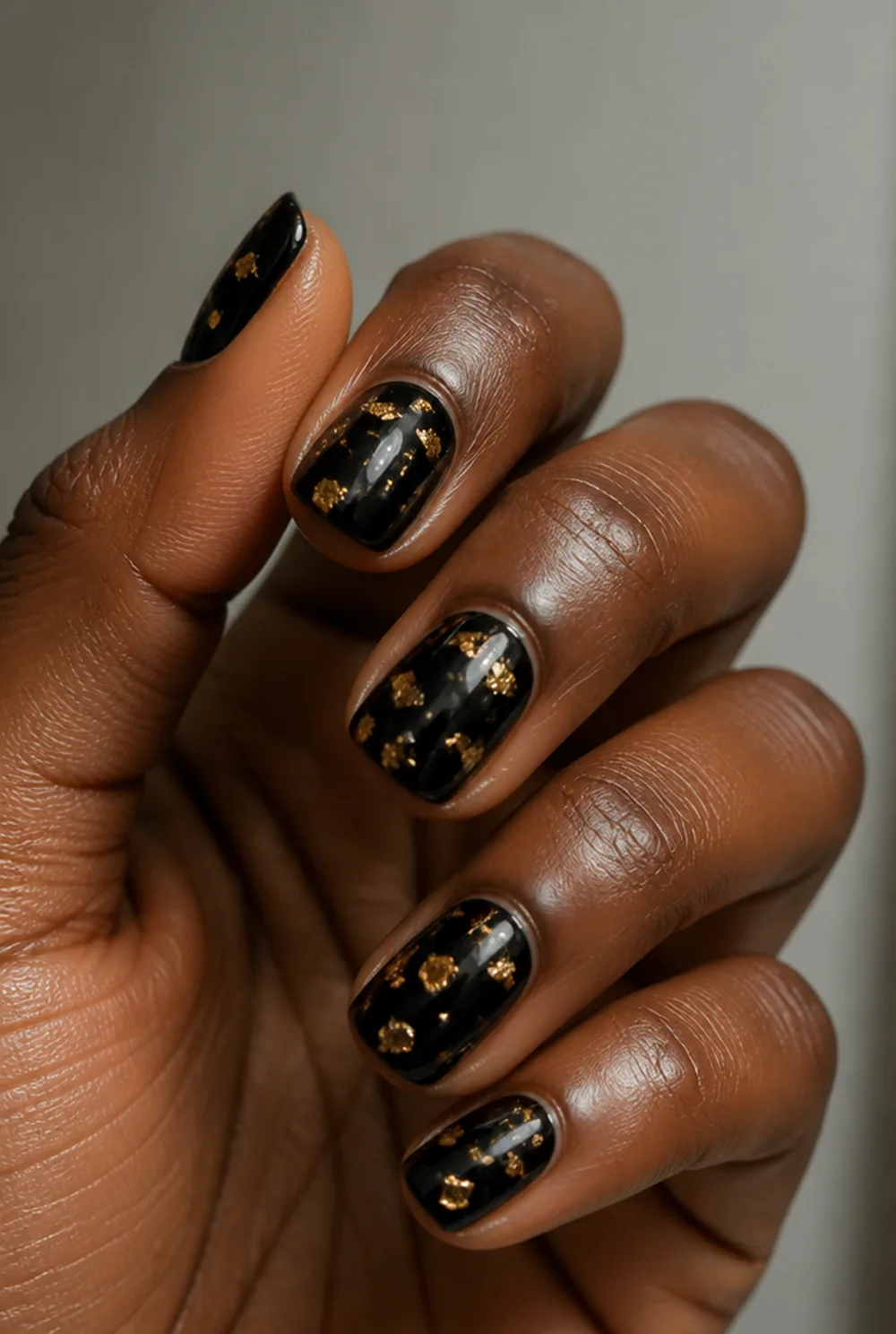 foil on black nail art on deep brown skin