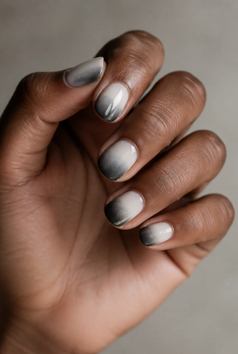 grey ombre nail art on deep brown skin