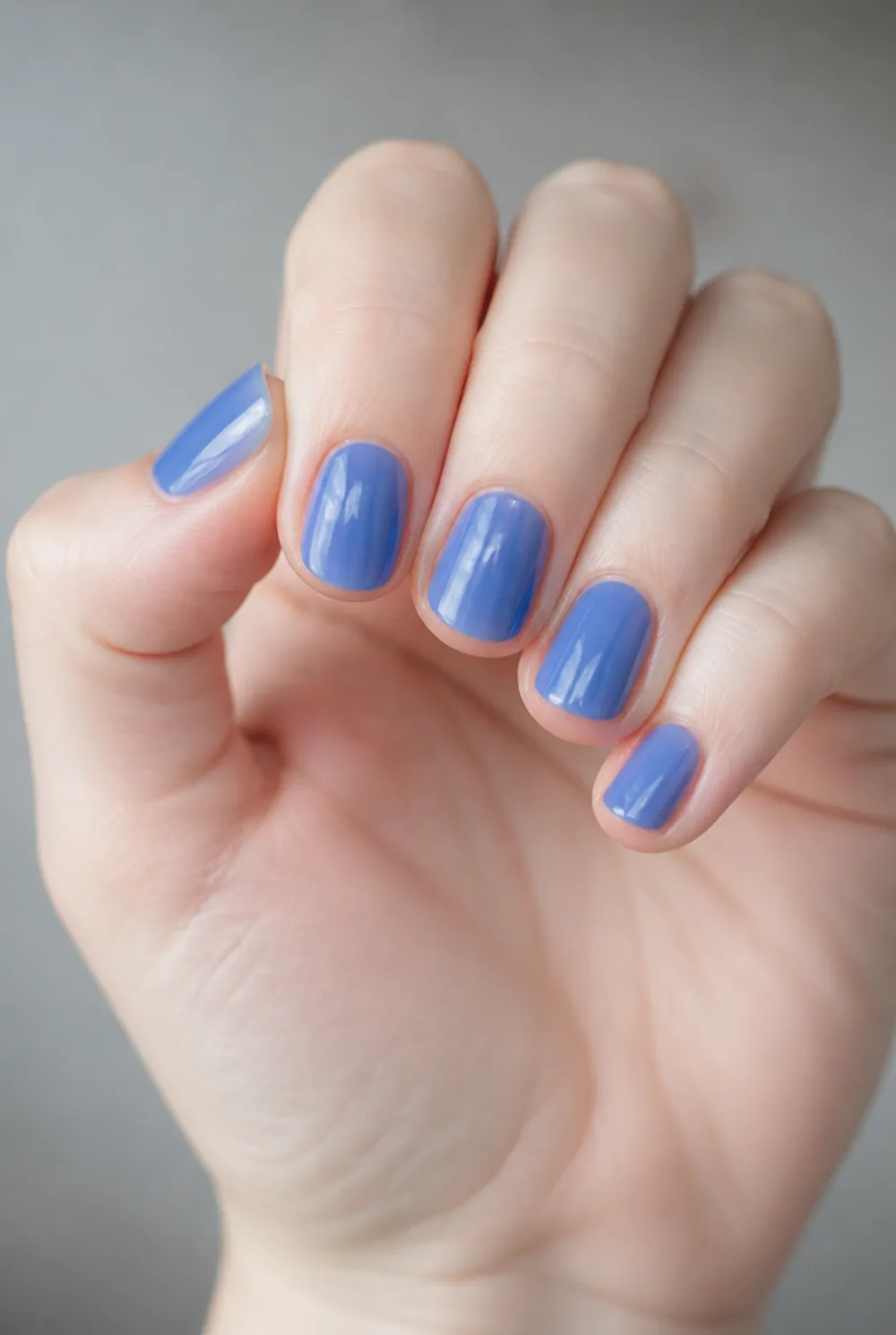 jelly blue nail art on fair skin, short length