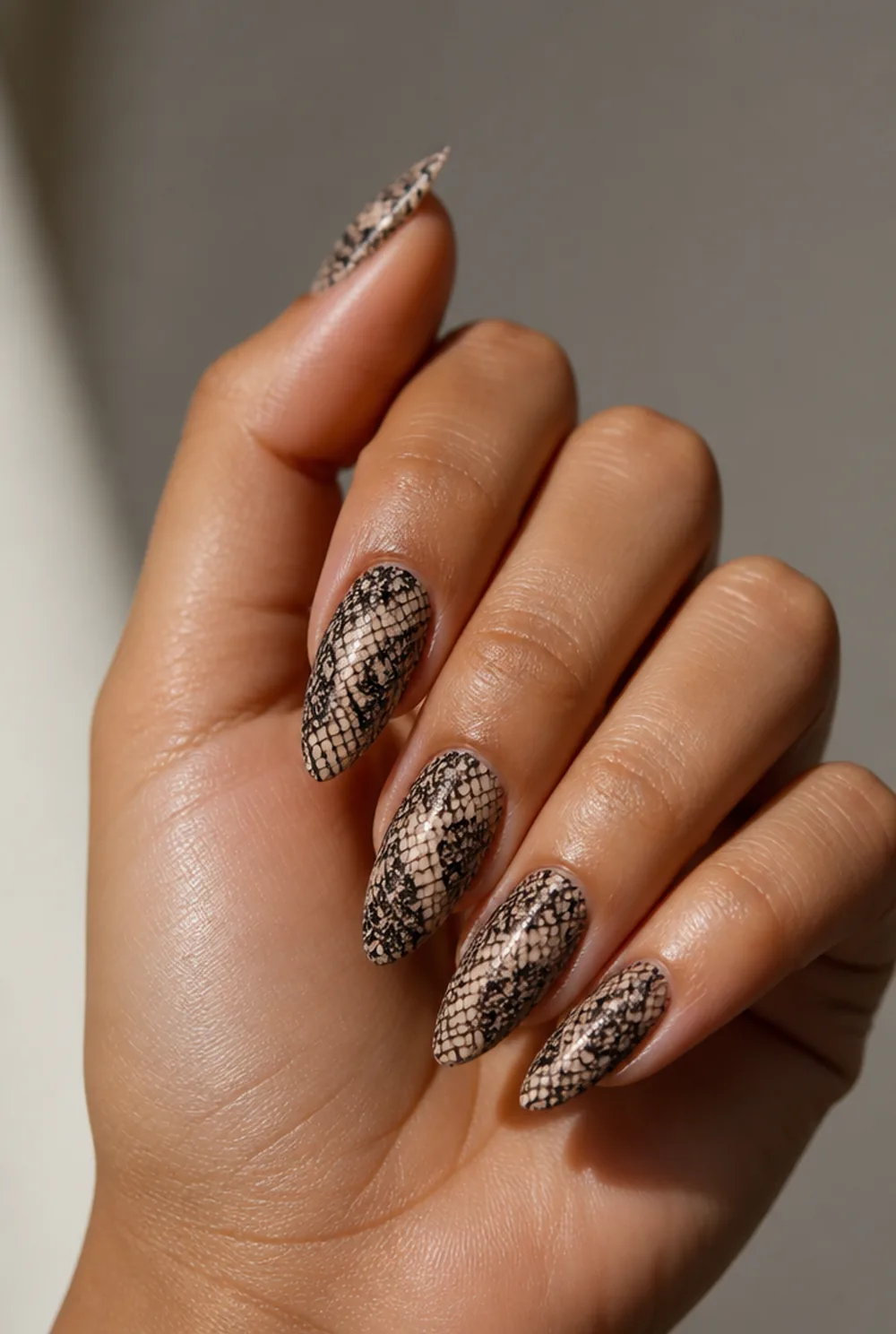 black lace on nude nail art on olive skin, long length