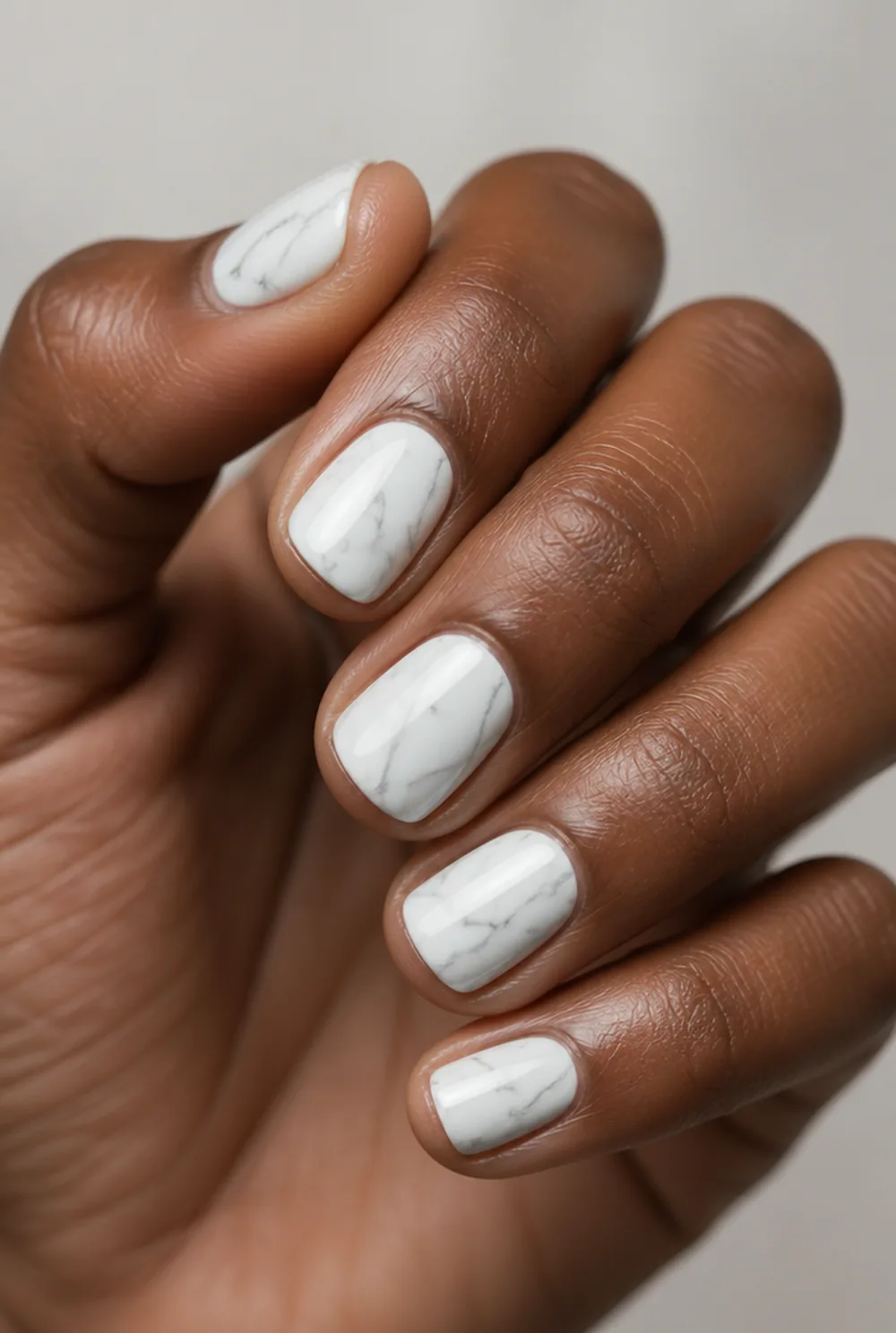 stamped marble veins nail art on deep brown skin