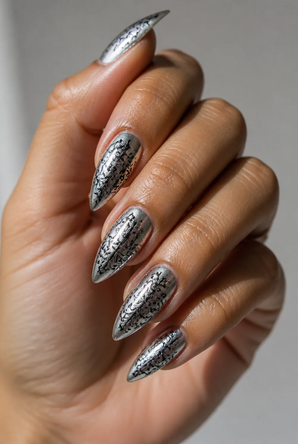 stamped over chrome nail art on olive skin, long length