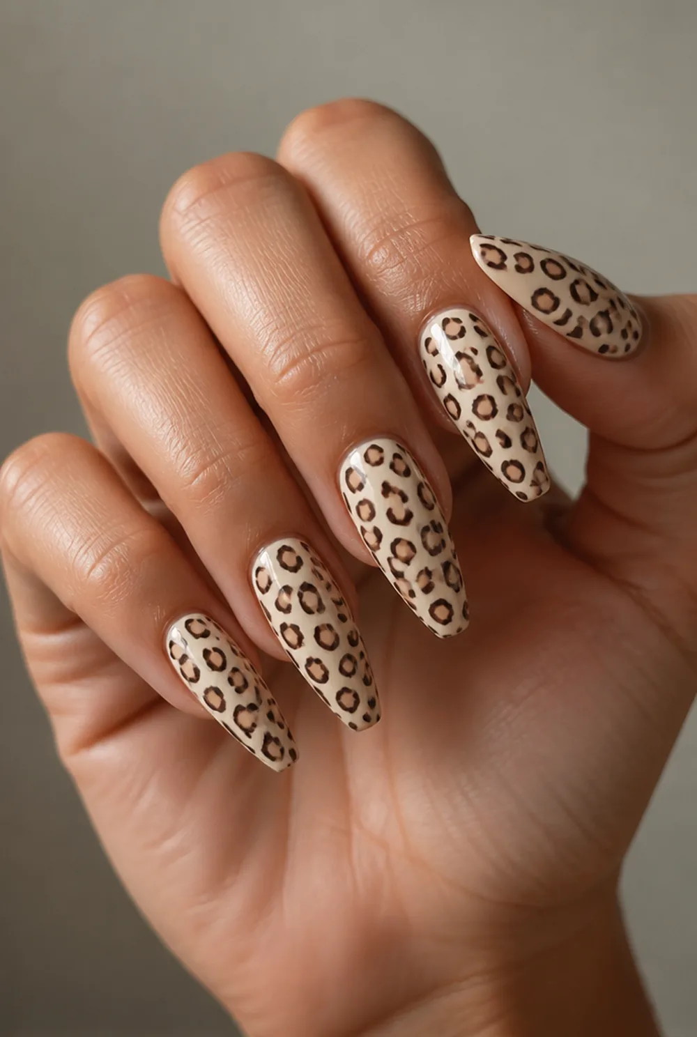 stamped leopard print nail art on olive skin, long length
