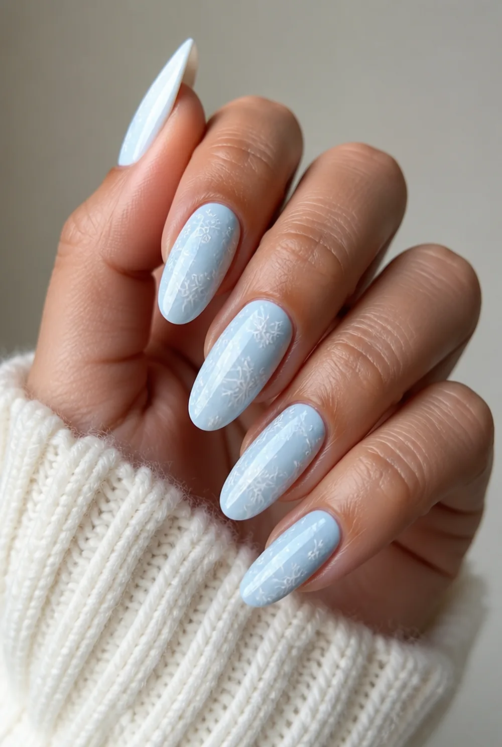 stamped snowflakes nail art on olive skin, long length
