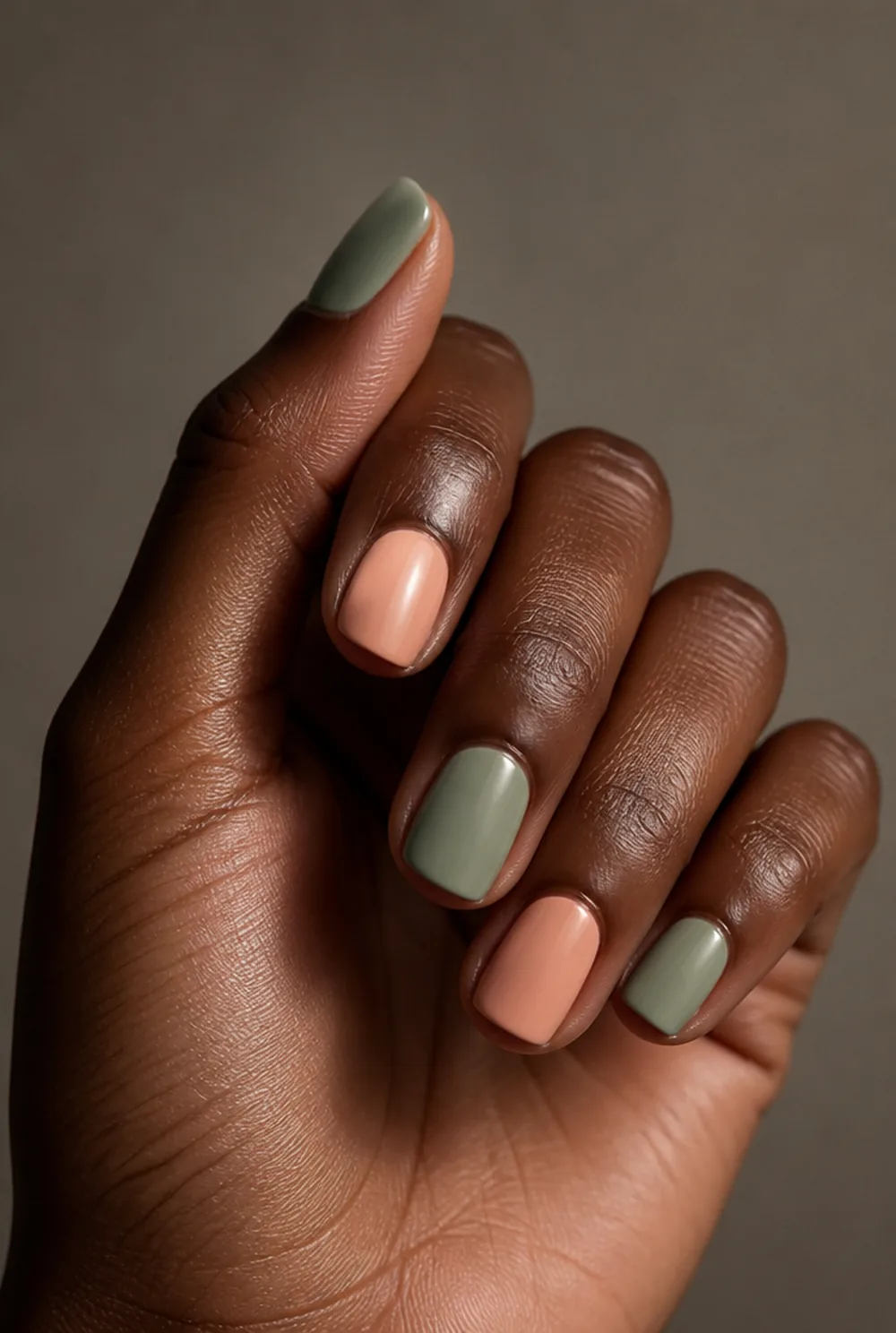peach and sage nail art on deep brown skin