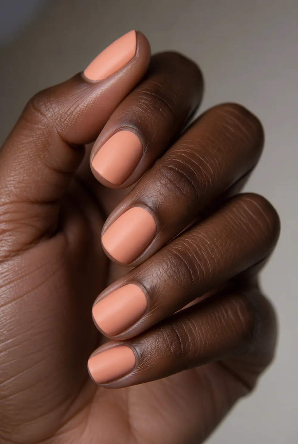 peach matte nail art on deep brown skin