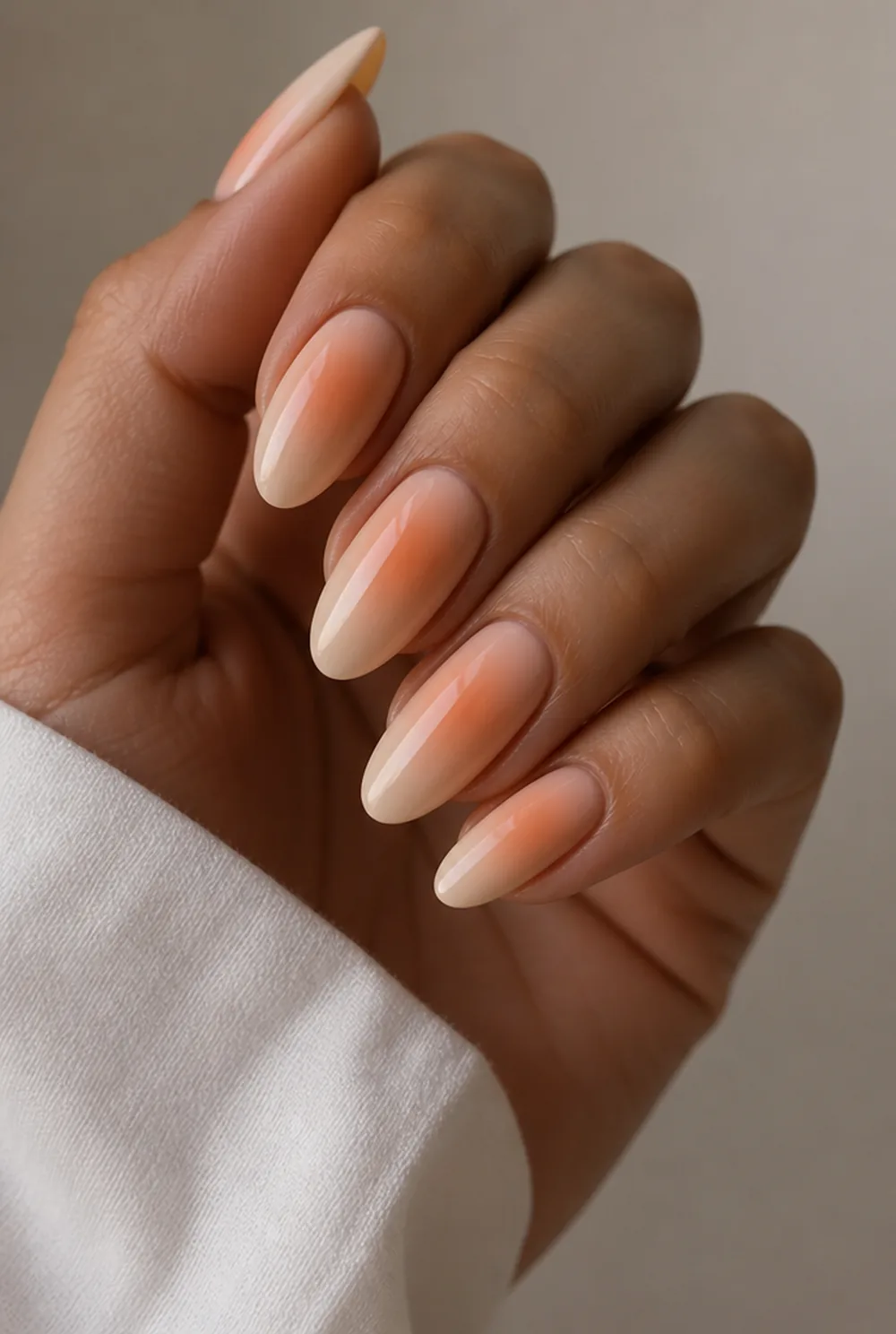 peach aura nail art on olive skin, long length