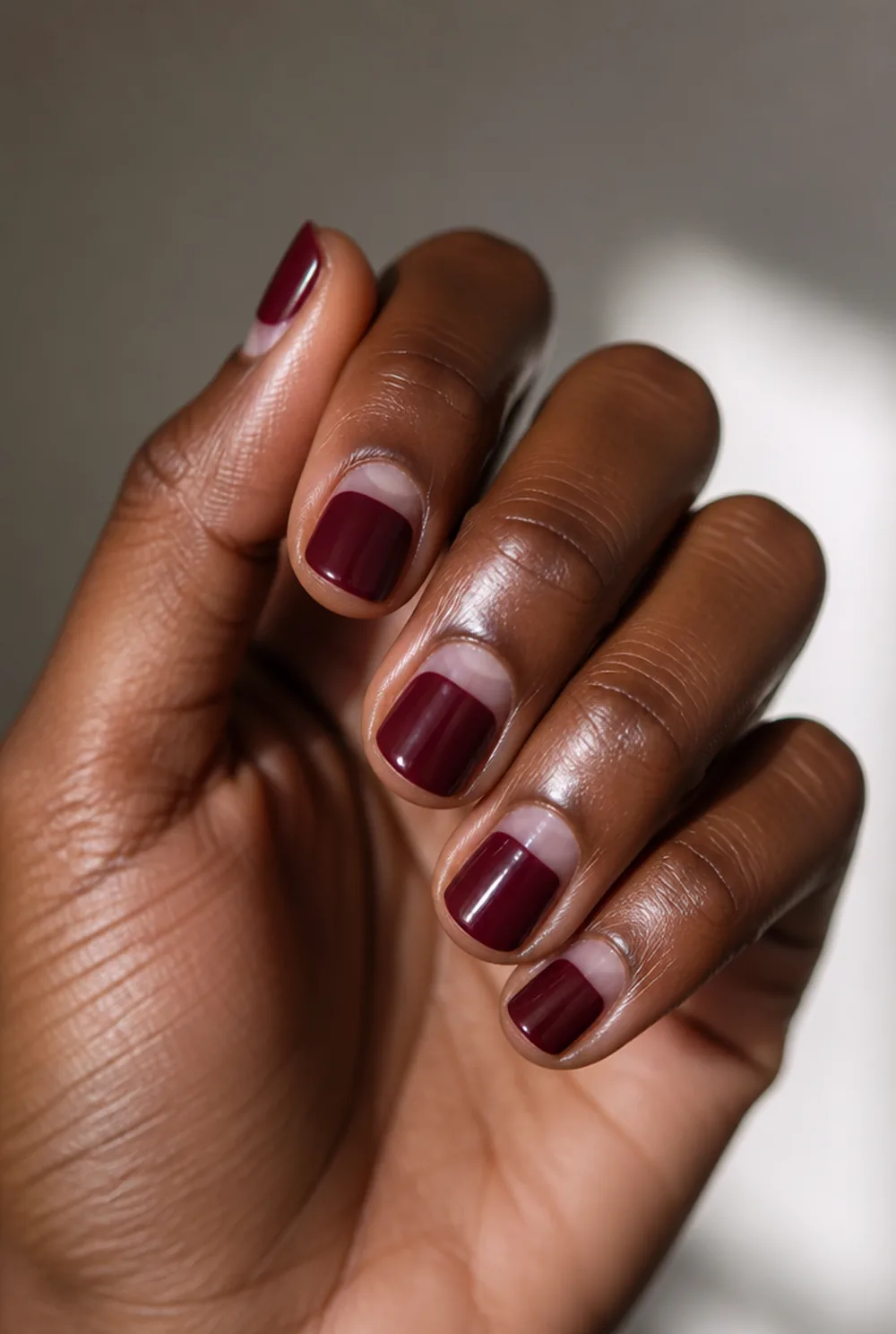 round half moon nail art on deep brown skin