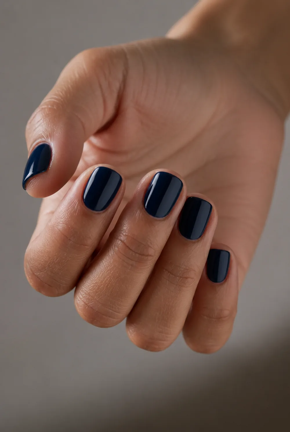 round navy nail art on olive skin, long length