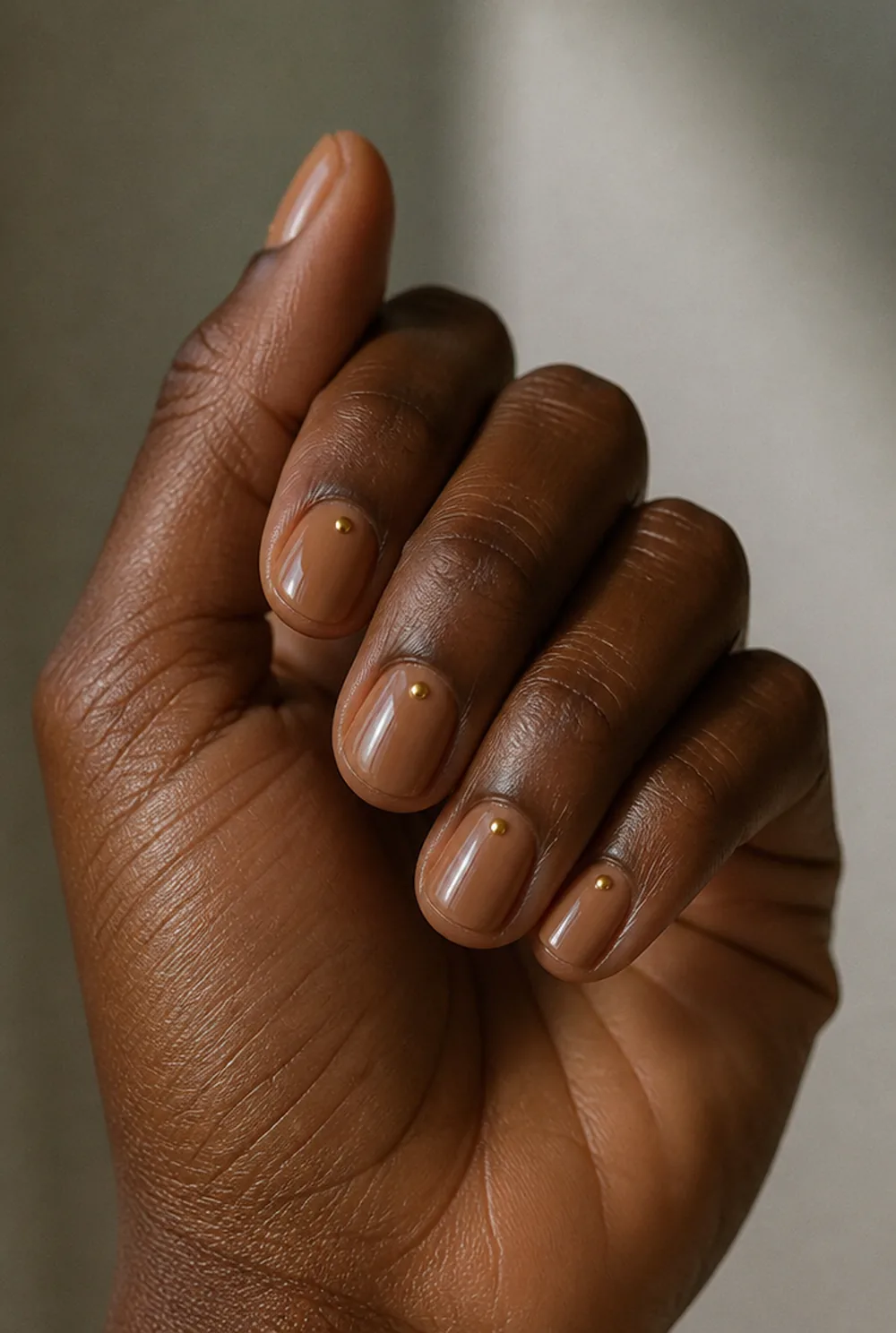 round with cuticle dot nail art on deep brown skin