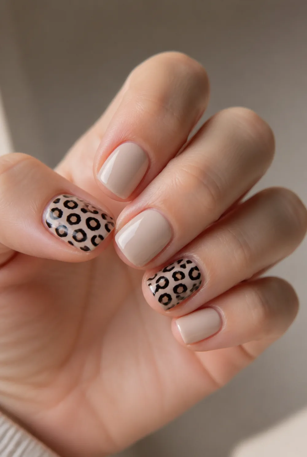 squoval leopard accent nail art on fair skin, short length