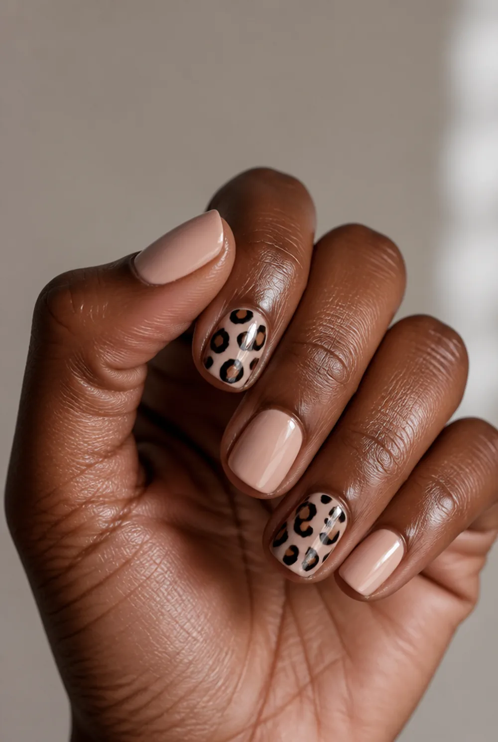 squoval leopard accent nail art on deep brown skin
