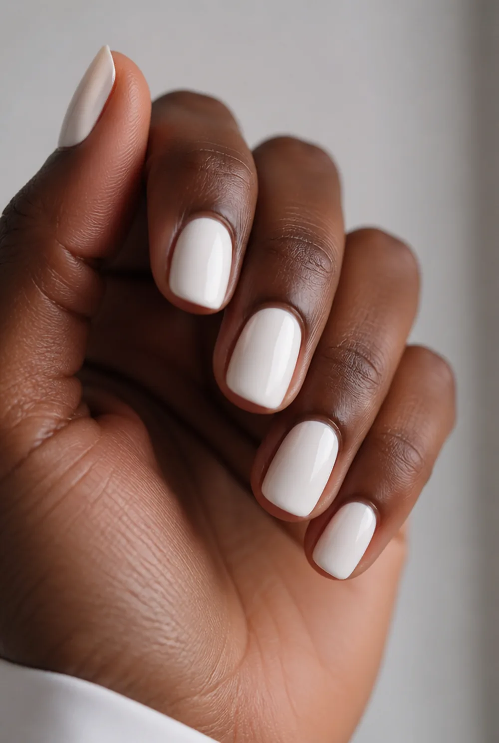 squoval milky white nail art on deep brown skin
