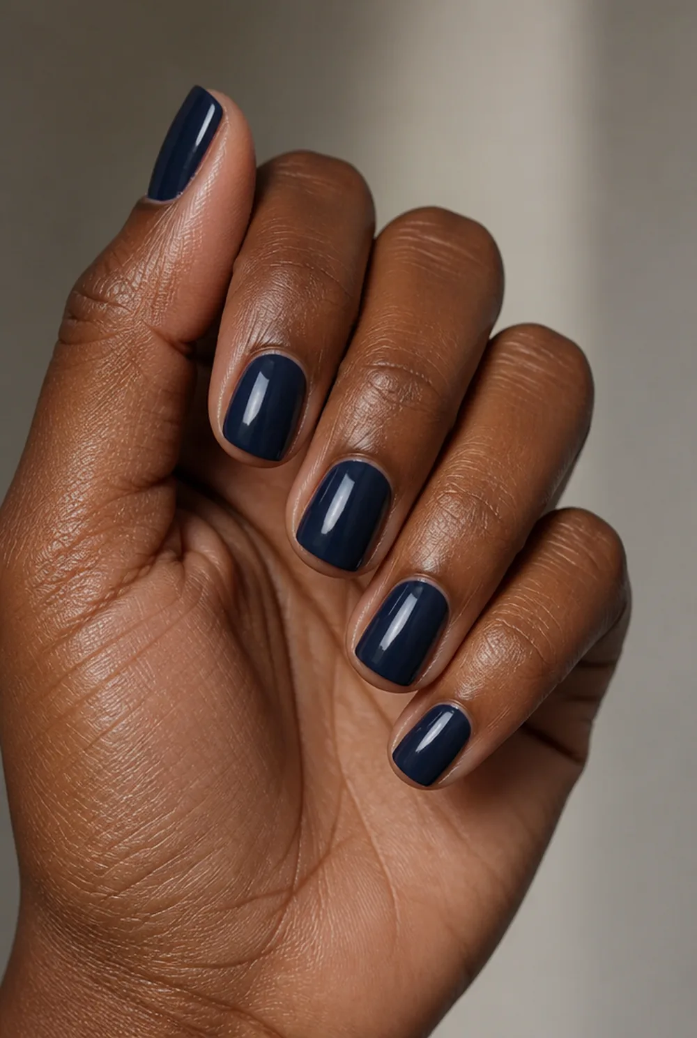 squoval navy nail art on deep brown skin
