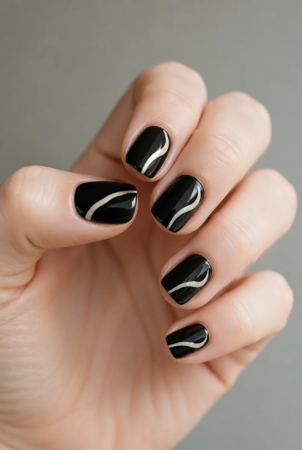 swirl on black nail art on fair skin, short length