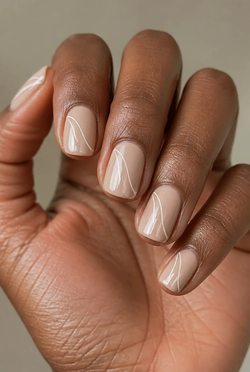 double swirl nail art on deep brown skin